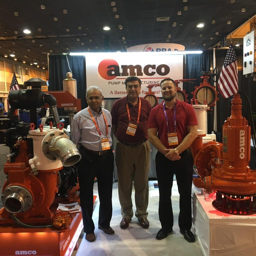 The AMCO Pump Manufacturing team at an industry trade show booth in Houston