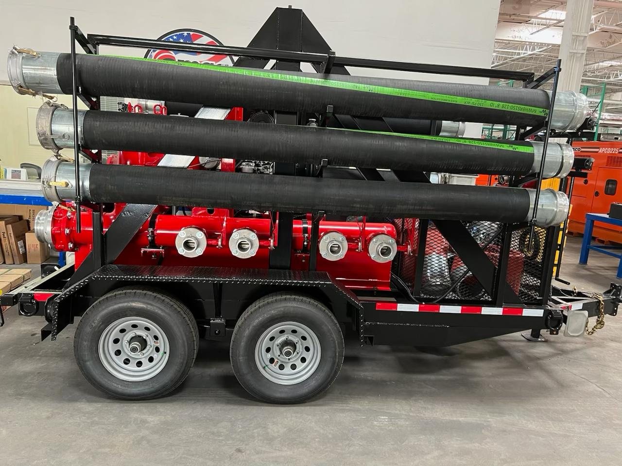 APCD trailer-mounted auto-prime pump loaded with layflat and hardwall suction hose for dewatering