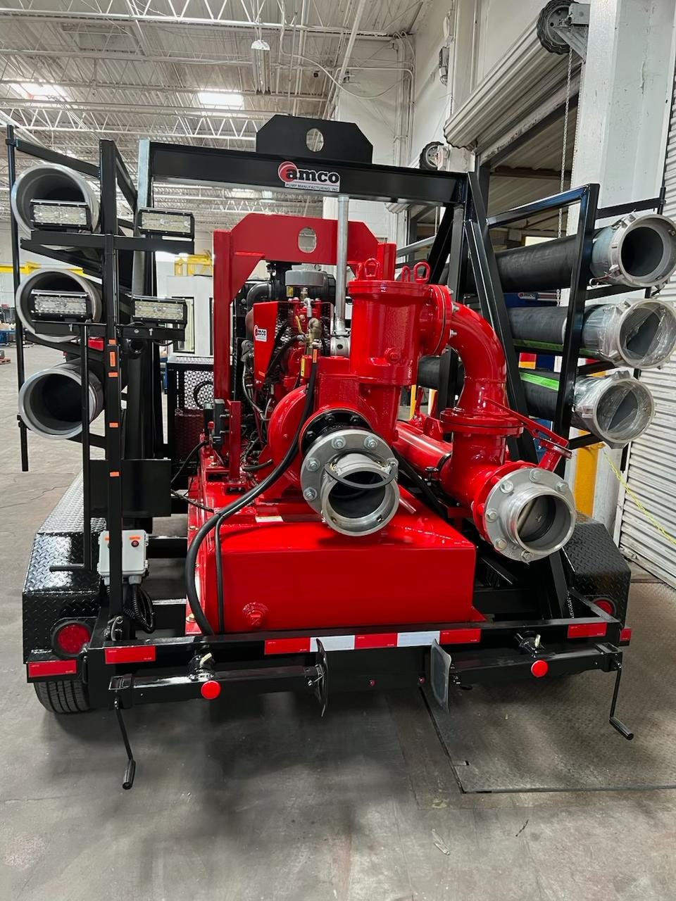 AMCO APCD auto-prime pump package on a highway trailer with suction pipe racks, Houston plant