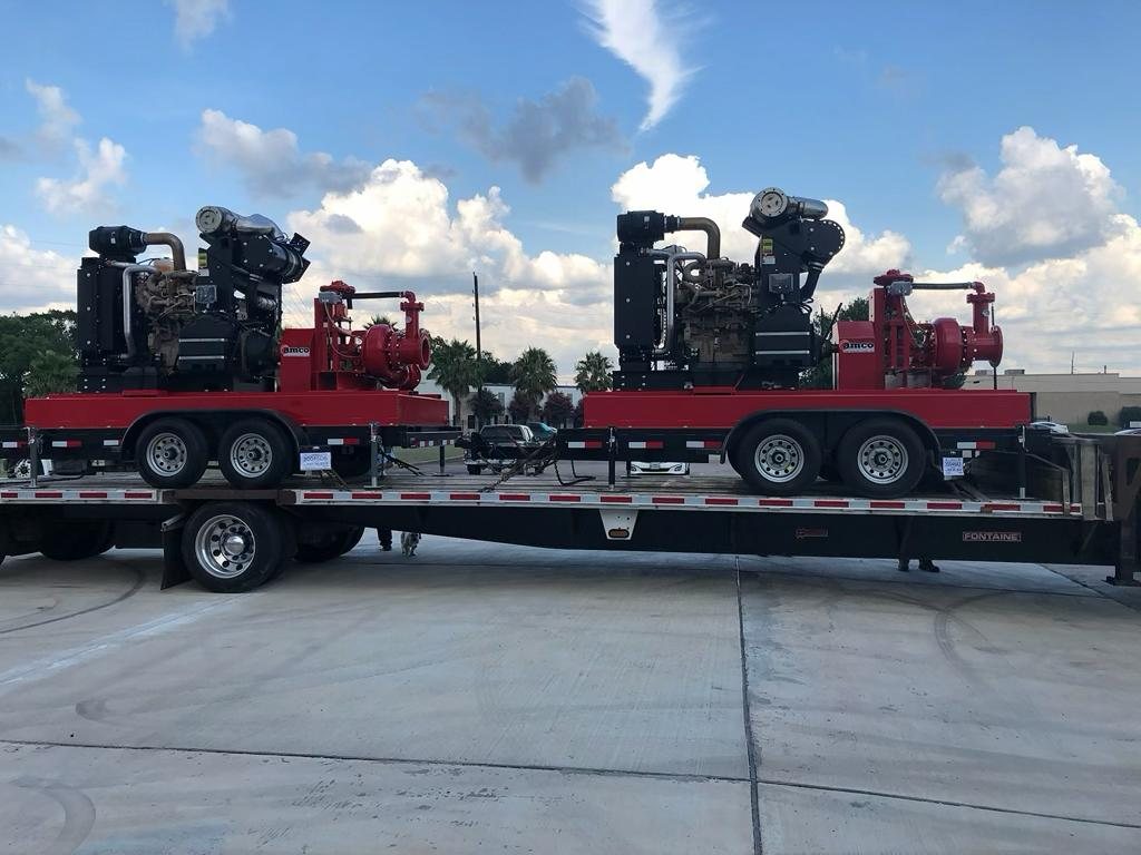 Pair of APHH high head pump units staged on a step-deck trailer outside the Houston plant